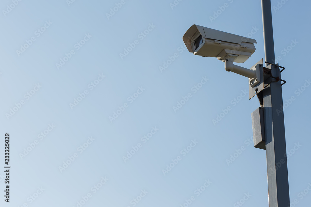 Security camera on blue sky background. Security view post Security camera on blue sky background. Security view post