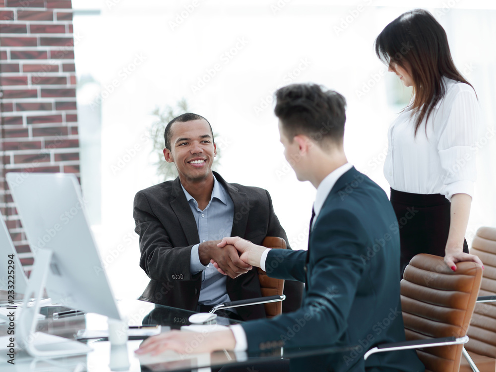 handshake business people behind a Desk in the office