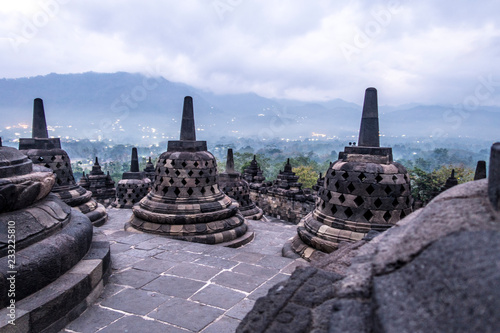 Sunrise among the stupas in Borobodur, a 9th-century Mahayana Buddhist complex in Magelang, Central Java, Indonesia photo