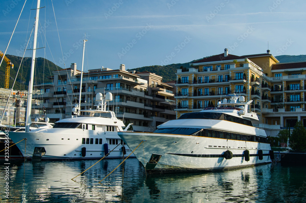 Large white yachts on the background of comfortable hotels.