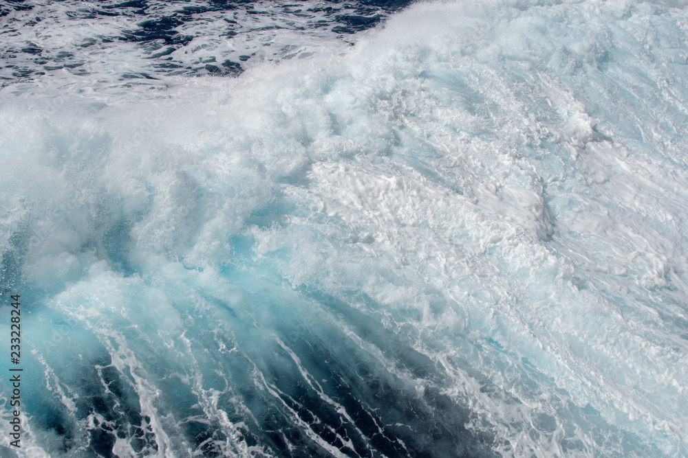 Ocean wave with sea foam at the top. Ocean wave with sea foam at the top.