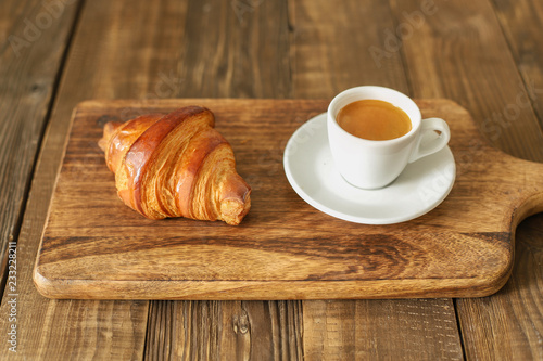 Bread and coffee espresso isolated on wooden table