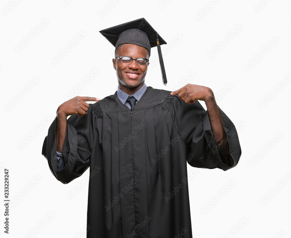 Young graduated african american man over isolated background looking confident with smile on face, pointing oneself with fingers proud and happy. Young graduated african american man over isolated background looking confident with smile on face, pointing oneself with fingers proud and happy.