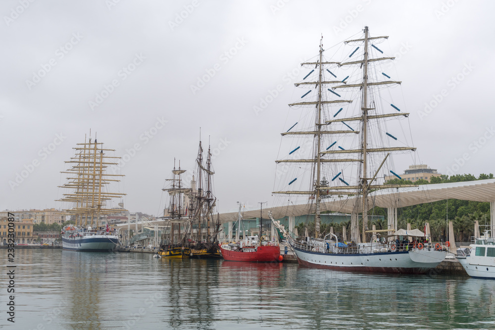 Multi-mast sailing ships at the pier in the port