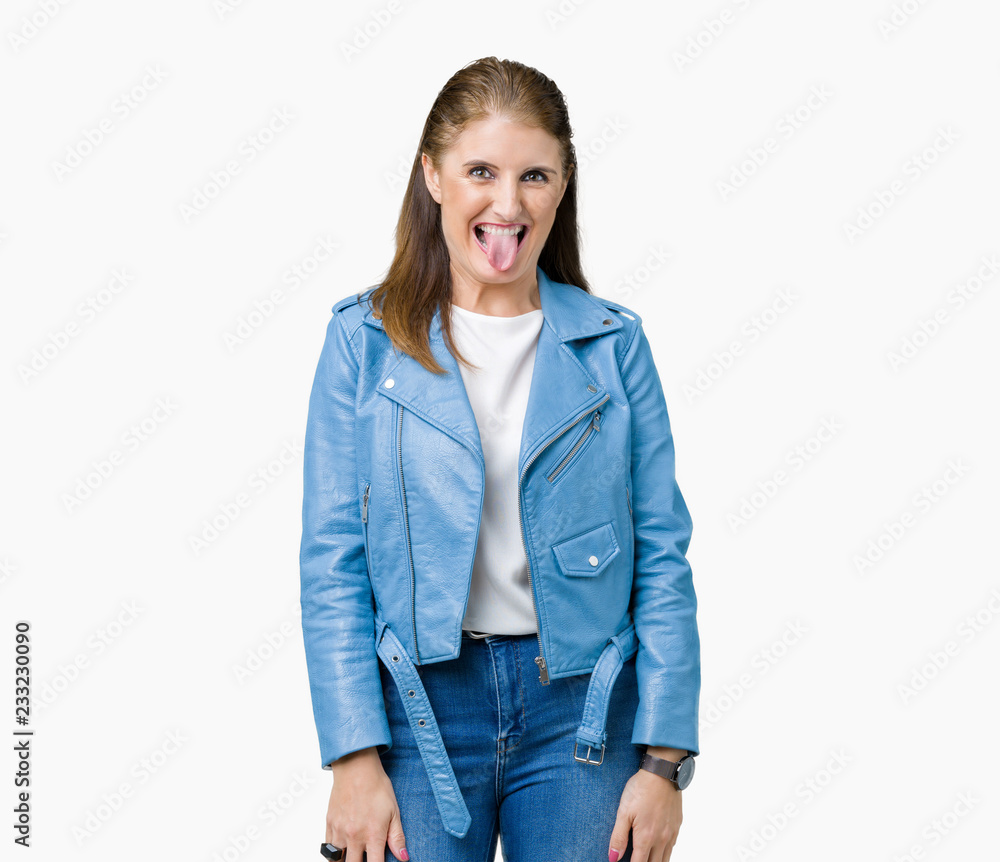 Beautiful middle age mature woman wearing fashion leather jacket over isolated background sticking tongue out happy with funny expression. Emotion concept. Beautiful middle age mature woman wearing fashion leather jacket over isolated background sticking tongue out happy with funny expression. Emotion concept.