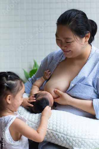 Asian mother with her baby girl in the balcony photo