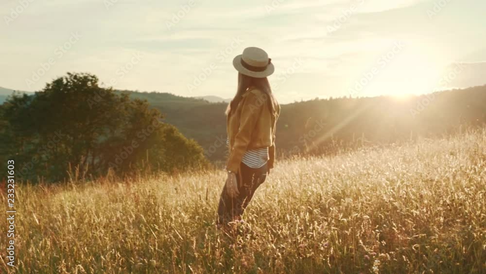 Slow motion young woman with hat walking in field touching wheat ears at sunset lifts his hands up smiling countryside nature summer girl sunshine freedom agriculture close up portrait slow motion Slow motion young woman with hat walking in field touching wheat ears at sunset lifts his hands up smiling countryside nature summer girl sunshine freedom agriculture close up portrait slow motion