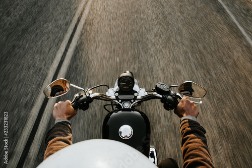 Motorcyclist holding handles photo