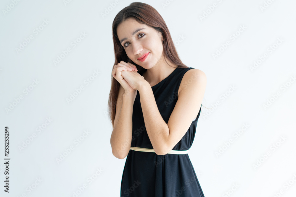 Portrait of happy young woman holding hands together and smiling. Asian girl  standing with excited expression. Adoration concept Stock Photo
