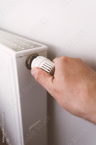 Men hand on battery temperature controller heating closeup