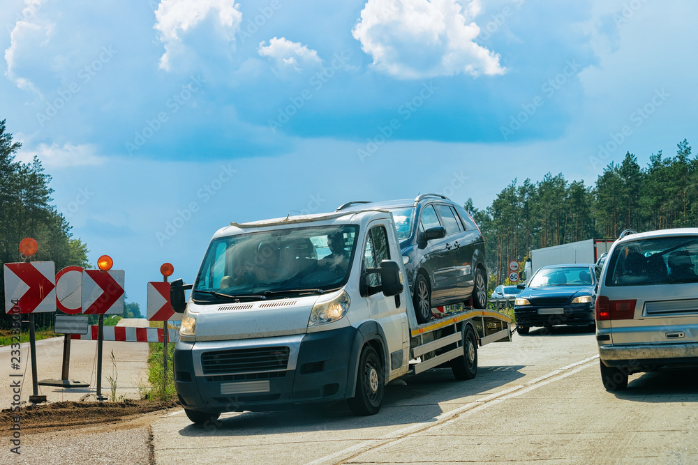 Obraz premium Tow truck with car on road Poland