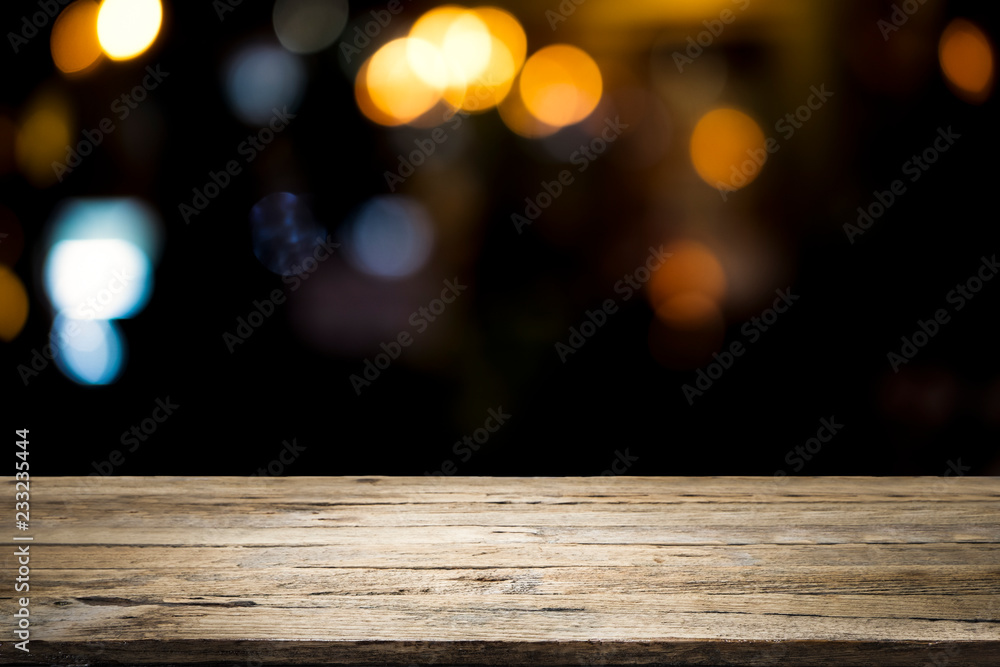 Empty wooden table platform and bokeh at night.