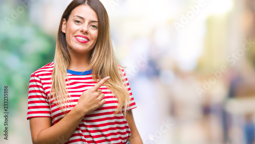 Wallpaper Mural Young beautiful woman casual look over isolated background cheerful with a smile of face pointing with hand and finger up to the side with happy and natural expression on face looking at the camera. Torontodigital.ca