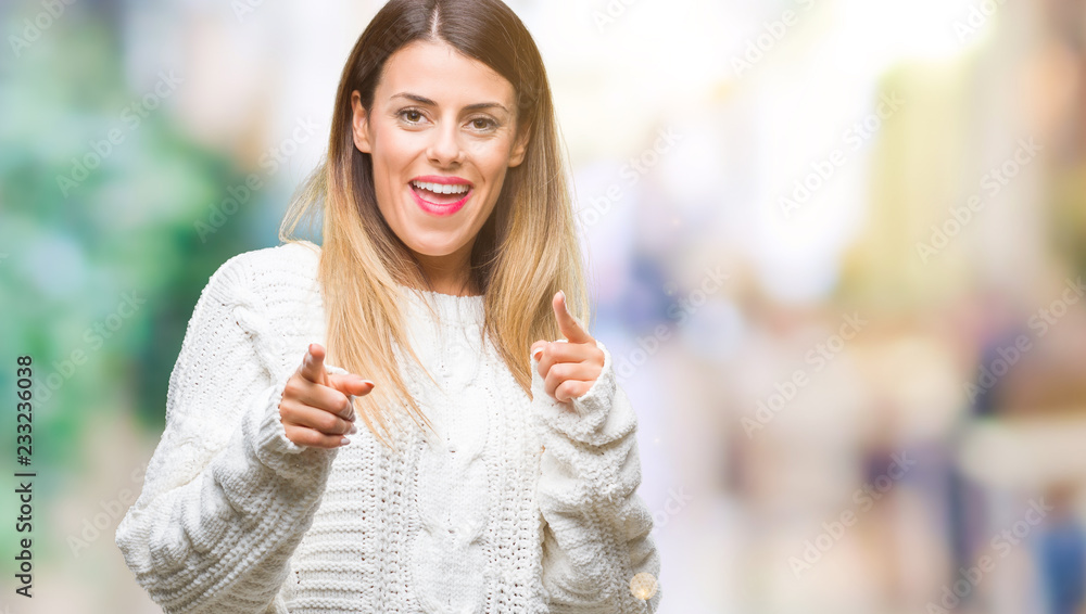 Young beautiful woman casual white sweater over isolated background pointing fingers to camera with happy and funny face. Good energy and vibes.