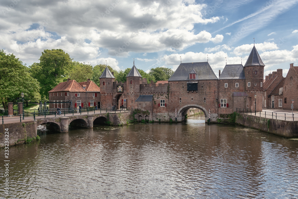 The canal Eem with in the background the medieval gate The Koppelpoort in the Dutch city of Amersfoort