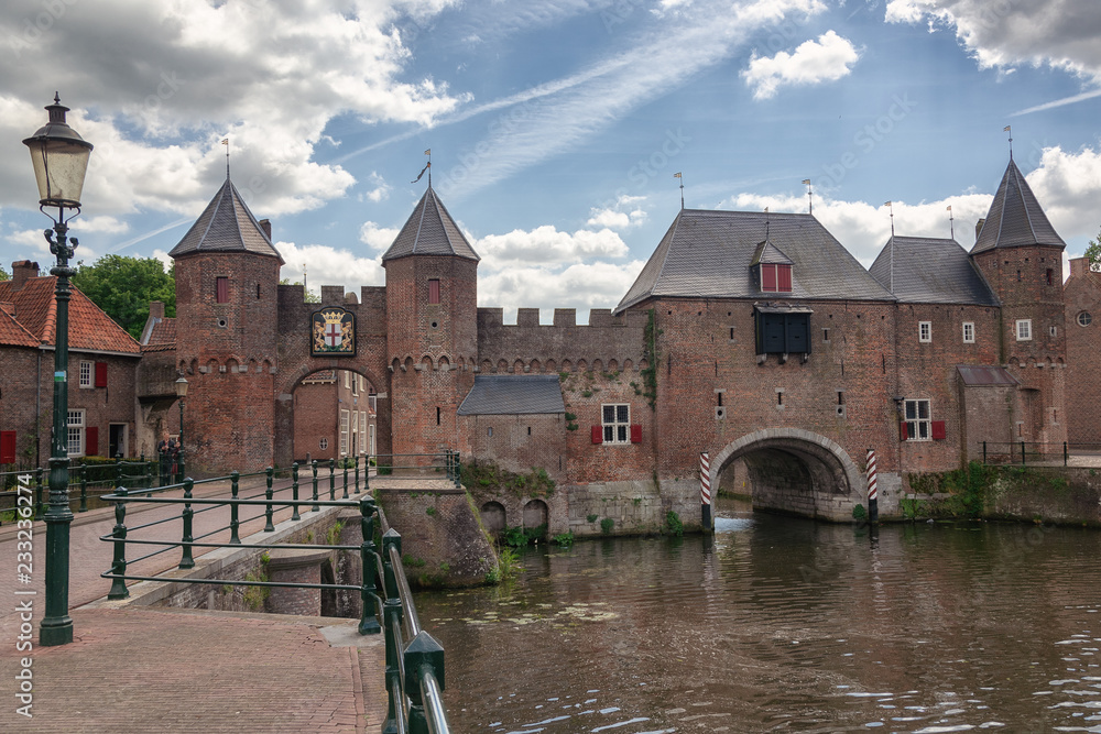 The canal Eem with in the background the medieval gate The Koppelpoort in the Dutch city of Amersfoort