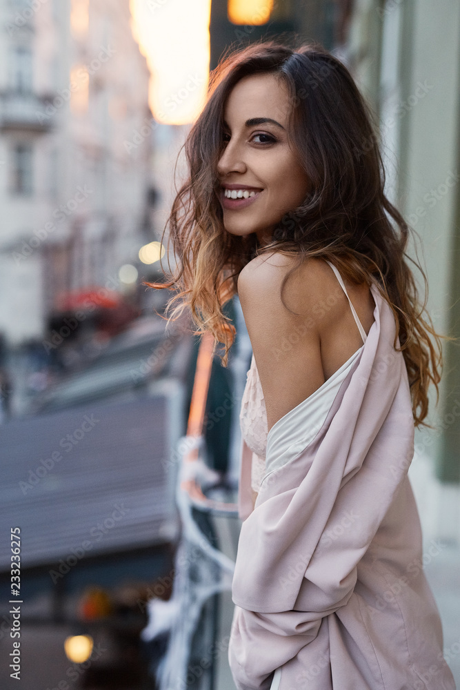 sensual portrait of a beautiful woman with long hair. sensual and sexy elegant woman posing outdoors on the street