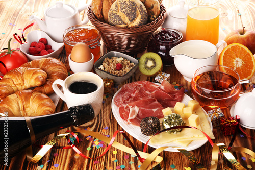 Photography breakfast on table with bread buns, croissants, coffe and juice on new years eve
