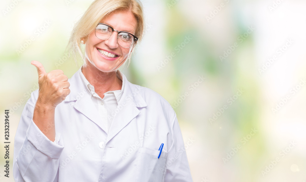 Middle age blonde therapist woman wearing white coat over isolated background doing happy thumbs up gesture with hand. Approving expression looking at the camera with showing success. Middle age blonde therapist woman wearing white coat over isolated background doing happy thumbs up gesture with hand. Approving expression looking at the camera with showing success.