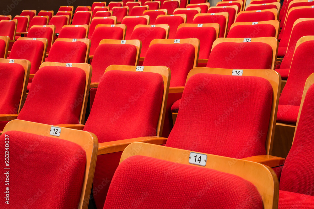 Naklejka premium Red chairs in the auditorium of the theater or concert hall.