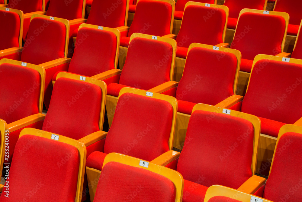 Fototapeta premium Red chairs in the auditorium of the theater or concert hall.