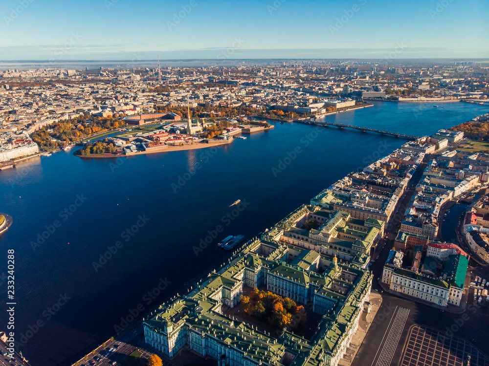 Top view aerial drone on buildings Palace embankment, wide Neva river with boats, bridge. Hare island and Peter and Paul fortress.