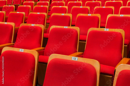 Red chairs in the auditorium of the theater or concert hall.