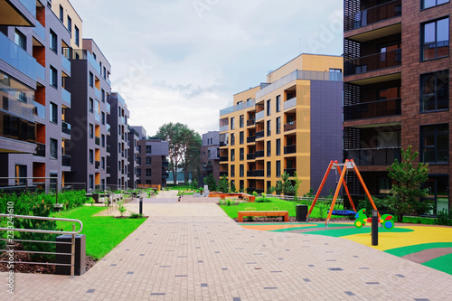 Children playground with European modern residential buildings quarter © Roman Babakin