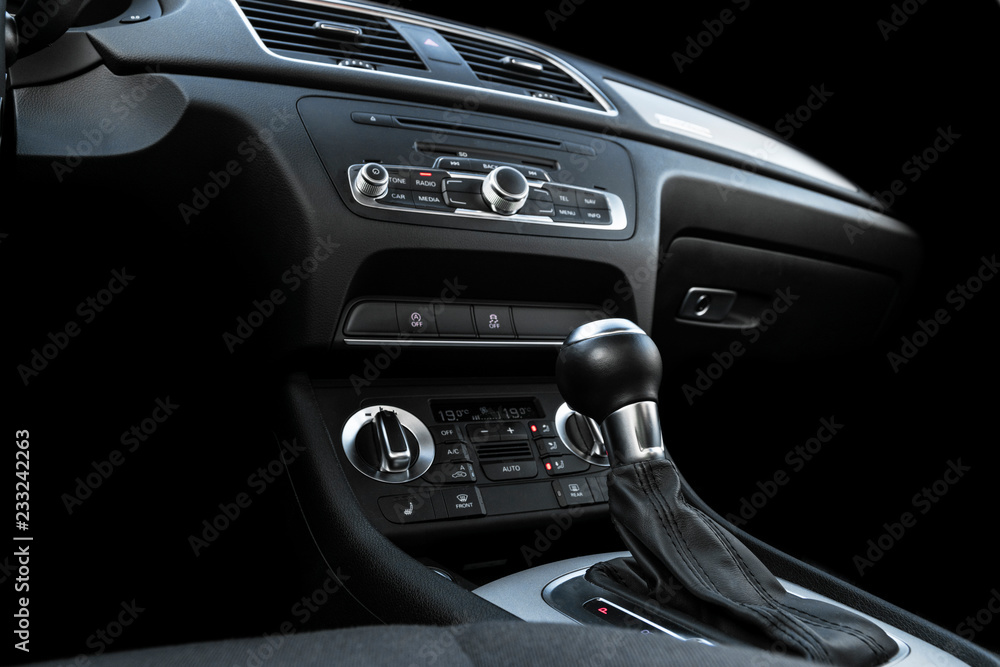 Modern Luxury sport car inside. Interior of prestige car. Black Leather. Car detailing. Dashboard. Media, climate and navigation control buttons. Sound system. Modern car interior details