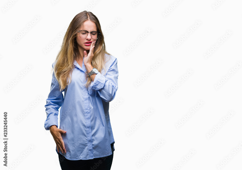 Young beautiful blonde business woman wearing glasses over isolated background touching mouth with hand with painful expression because of toothache or dental illness on teeth. Dentist concept. Young beautiful blonde business woman wearing glasses over isolated background touching mouth with hand with painful expression because of toothache or dental illness on teeth. Dentist concept.