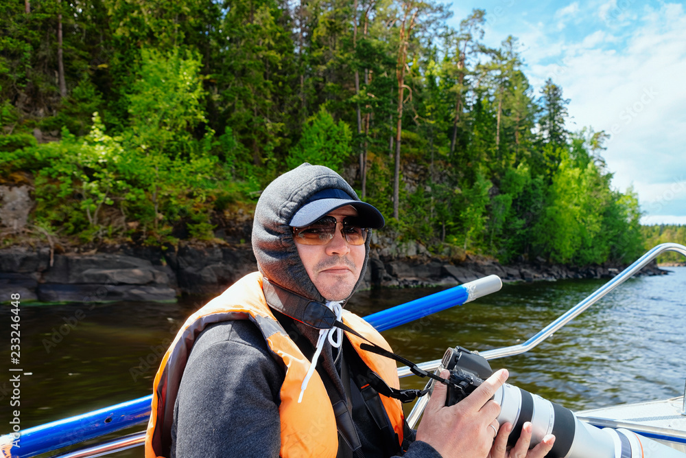 Man taking photos on Ladoga Lake in Karelia Man taking photos on Ladoga Lake in Karelia