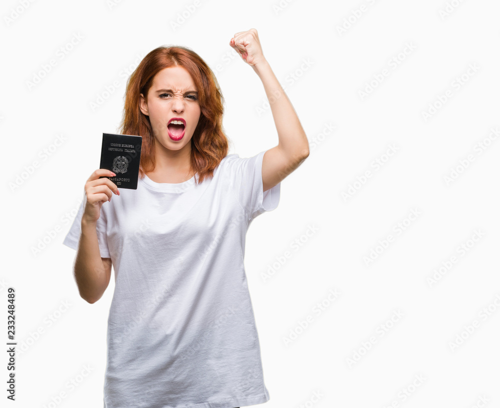 Obraz premium Young beautiful woman holding passport of italy over isolated background annoyed and frustrated shouting with anger, crazy and yelling with raised hand, anger concept