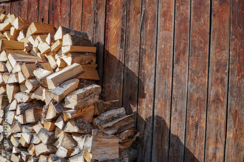 Pile of firewood.prepared to fireplace for the winter and use for cooking firewood background Stacks of firewood arranged in a row in the forest.Material for heating the house.Ecological natural fuel.