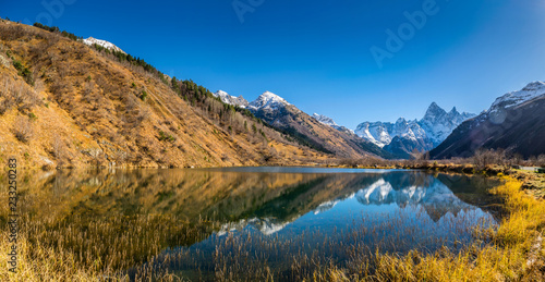 Panoramic landscape, view on beautiful autumn mountain lake Tumanly-kel, the Mist lake, located in Russia, near Dombay , in Caucasus mountains, Gonachkhir gorge