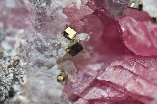 Pink crystals Rhodochrosite with particles of Pyrite. Natural  texture of mineral for background. Beautiful background and wallpaper. Macro. photo