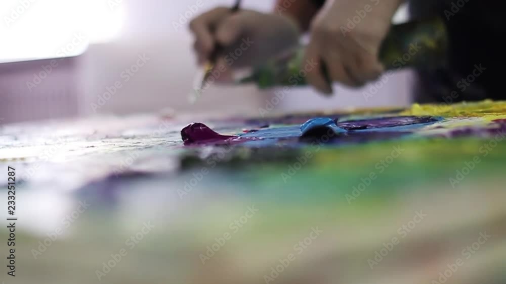 Close up hand artist mixes paints on the palette before painting a picture at the studio creativity background image macro pattern abstraction detail green purple canvas easel education hobbies Close up hand artist mixes paints on the palette before painting a picture at the studio creativity background image macro pattern abstraction detail green purple canvas easel education hobbies