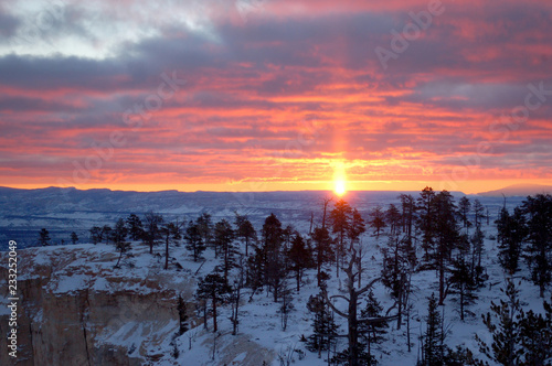 The sun rises over Bryce Canyon National Park in Utah on a cold snowy morning