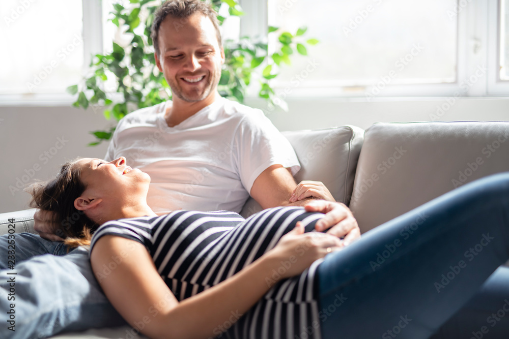 A pregnancy and people concept happy man pregnant woman at home - obrazy, fototapety, plakaty 