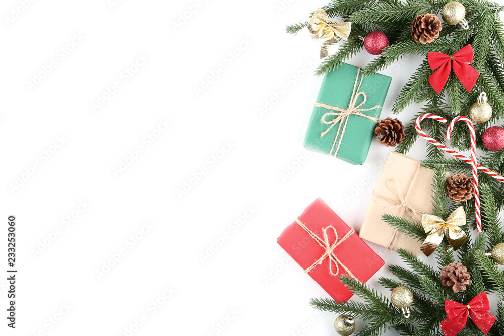 Christmas fir tree branches with gift boxes and candy canes on white background Christmas fir tree branches with gift boxes and candy canes on white background