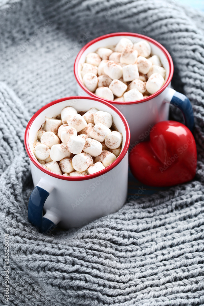 Cappuccino with marshmallows in mugs, red heart and knitted scarf Cappuccino with marshmallows in mugs, red heart and knitted scarf