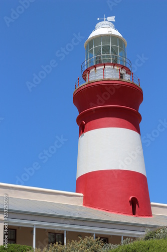 A red and white lighthouse at L'Agulhas in South Africa. This is a popular tourist attraction.  photo