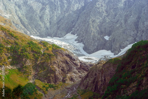 mountain landscape with a melting glacier in a valley in the North Caucasus