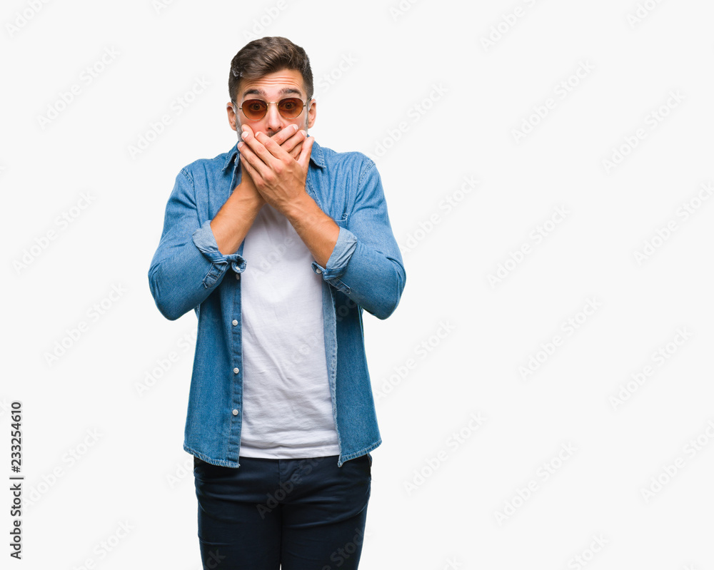 Young handsome man wearing sunglasses over isolated background shocked covering mouth with hands for mistake. Secret concept. Young handsome man wearing sunglasses over isolated background shocked covering mouth with hands for mistake. Secret concept.