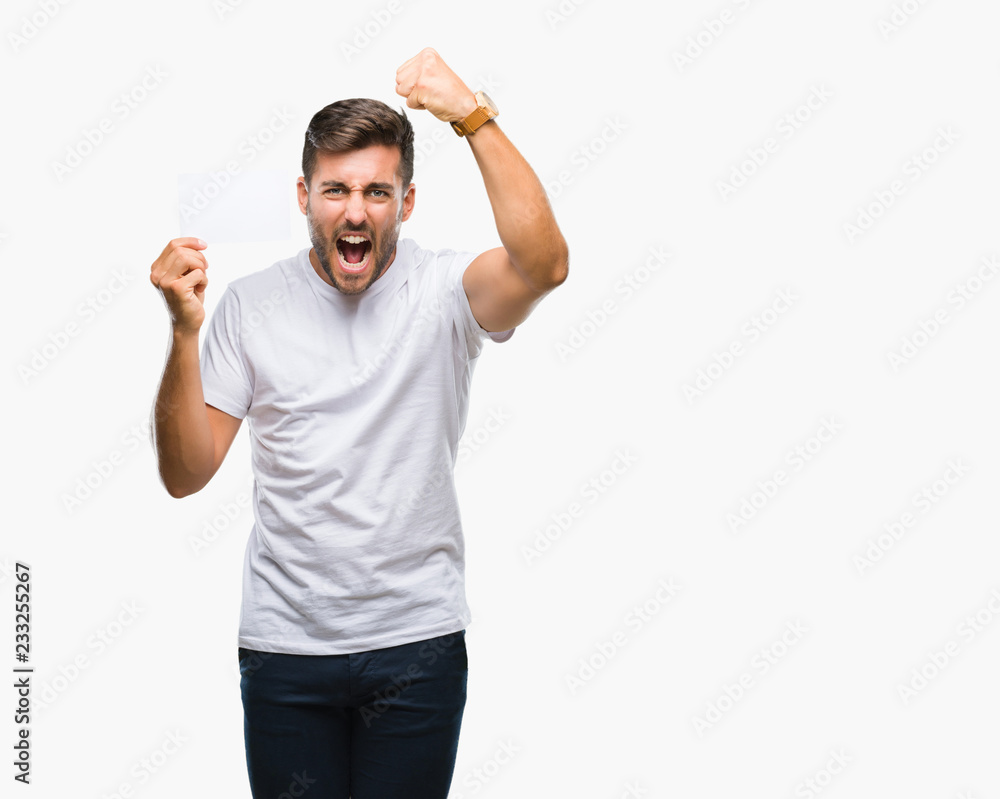 Fototapeta premium Young handsome man holding blank card over isolated background annoyed and frustrated shouting with anger, crazy and yelling with raised hand, anger concept