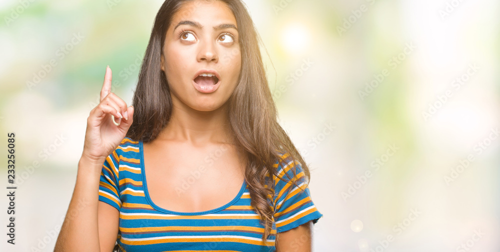Young beautiful arab woman over isolated background pointing finger up with successful idea. Exited and happy. Number one. Young beautiful arab woman over isolated background pointing finger up with successful idea. Exited and happy. Number one.