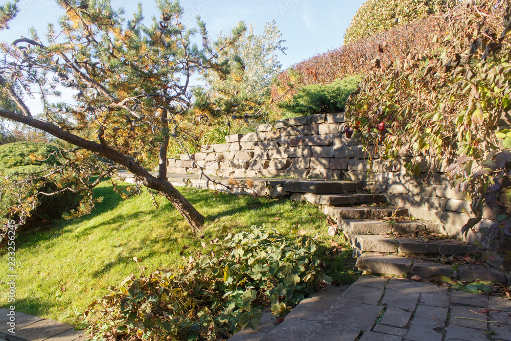 Cottage garden with stone stairs and retaining wall
