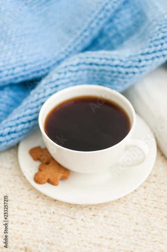 Cup of hot black coffee with christmas gingerbread cookie man, traditional holiday sweet. Winter background