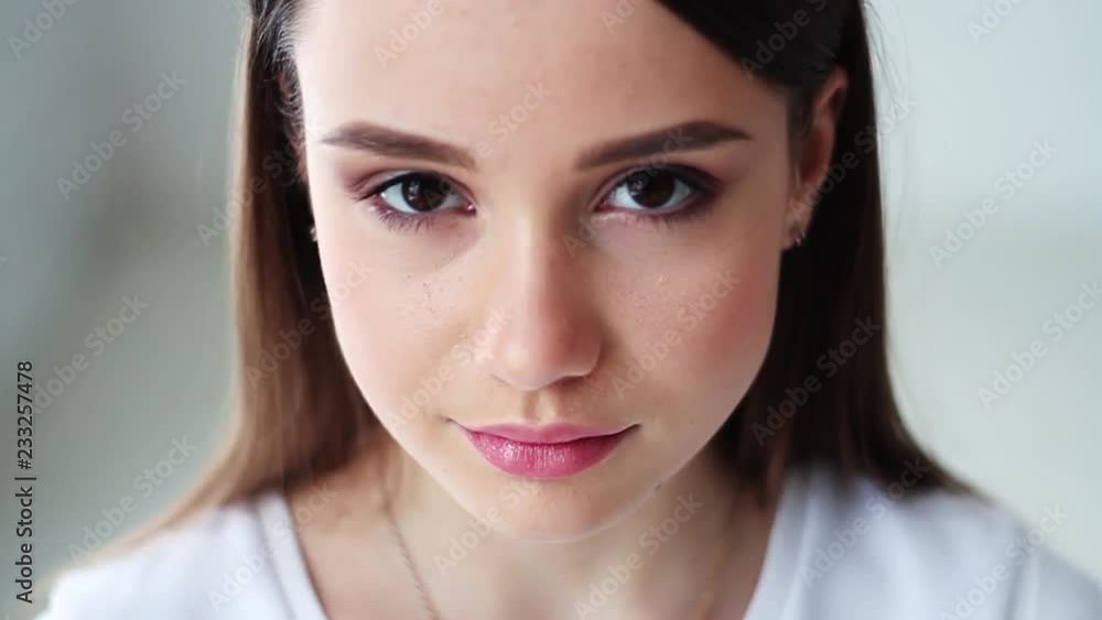 Smiling portrait of the beautiful young woman looking at camera happy ...