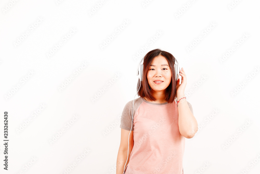 Portrait of beautiful asian young woman with brunette hair and bob hairstyle, fashionable hipster outfit alone in bright lighted room. Background, copy space for text, close up. Portrait of beautiful asian young woman with brunette hair and bob hairstyle, fashionable hipster outfit alone in bright lighted room. Background, copy space for text, close up.