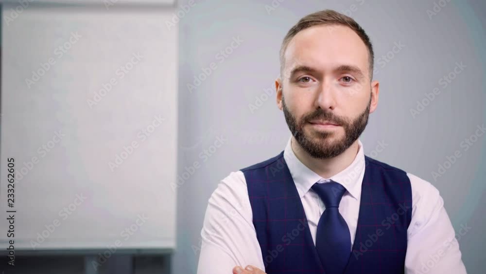 Portrait of confident bearded male wearing tie and suit looking at camera enjoying break. Portrait of confident bearded male wearing tie and suit looking at camera enjoying break.